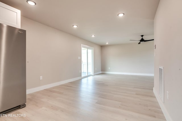 empty room featuring baseboards, visible vents, light wood finished floors, recessed lighting, and ceiling fan