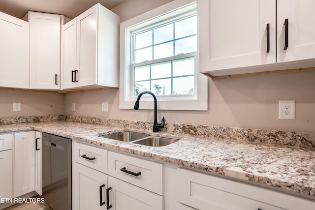 kitchen with a sink, dishwasher, and white cabinets