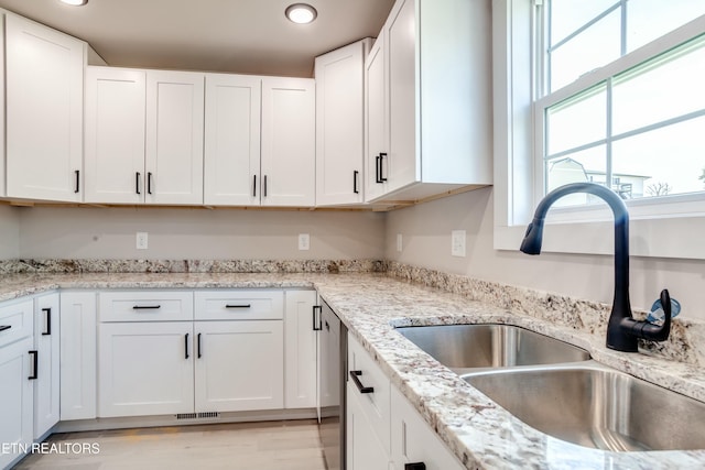 kitchen with white cabinetry, recessed lighting, visible vents, and a sink