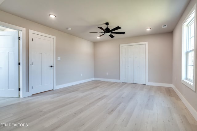 unfurnished bedroom featuring visible vents, baseboards, light wood-type flooring, recessed lighting, and a closet