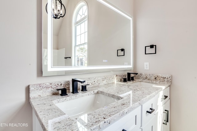 full bathroom featuring double vanity and a sink