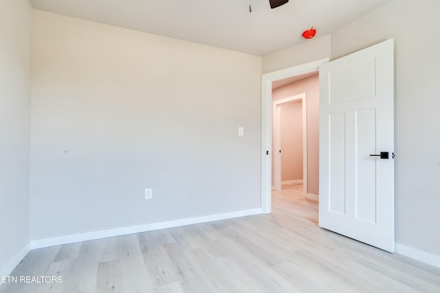 unfurnished bedroom with baseboards and light wood-style floors