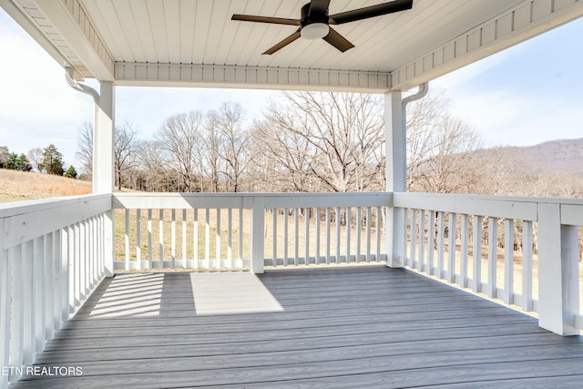 wooden deck featuring a ceiling fan