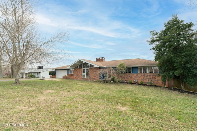 single story home featuring a front lawn, a garage, brick siding, and a chimney