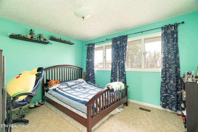 bedroom featuring visible vents, carpet flooring, a textured ceiling, and baseboards