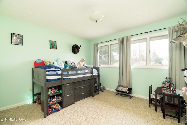 carpeted bedroom featuring baseboards