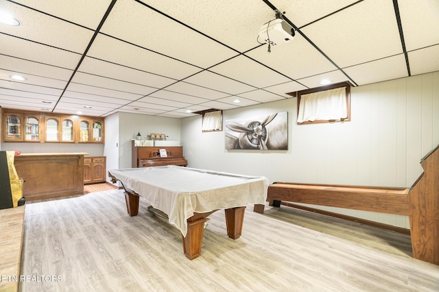 playroom featuring billiards, bar area, wood finished floors, and a drop ceiling