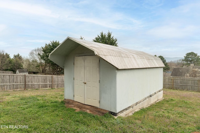 view of shed with a fenced backyard