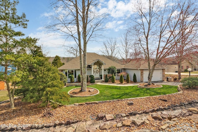 view of front of house featuring driveway, a front lawn, a garage, and a shingled roof