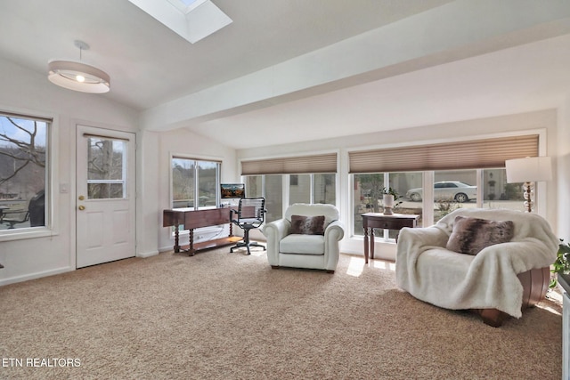 living area with vaulted ceiling with skylight, carpet flooring, and baseboards