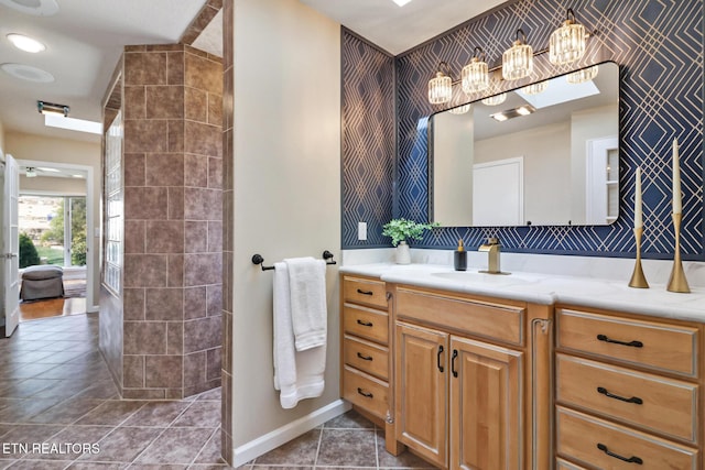 full bath featuring tile patterned flooring, vanity, and baseboards