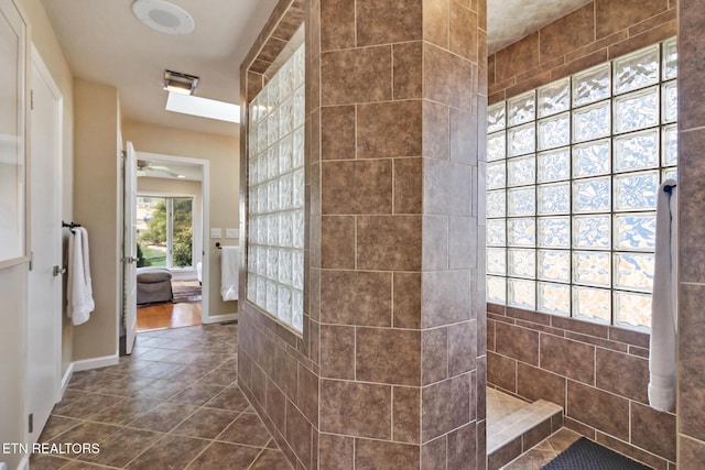 bathroom featuring tile patterned floors, connected bathroom, and a ceiling fan