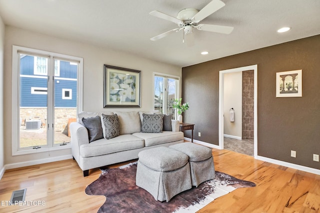 living area with recessed lighting, a ceiling fan, baseboards, and light wood finished floors