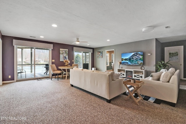 carpeted living area featuring a wealth of natural light, visible vents, recessed lighting, and a ceiling fan