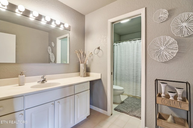 full bathroom featuring toilet, curtained shower, vanity, and a textured wall