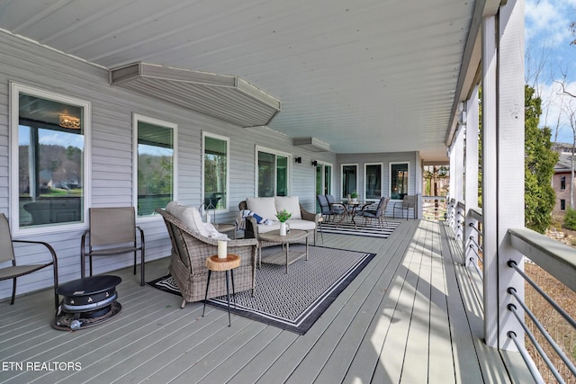 wooden terrace featuring outdoor lounge area