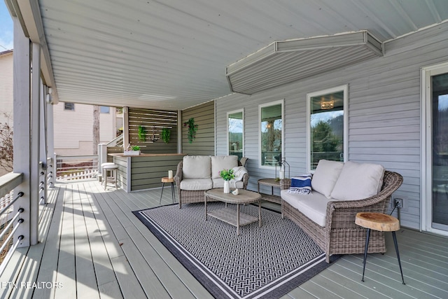 wooden terrace with an outdoor hangout area