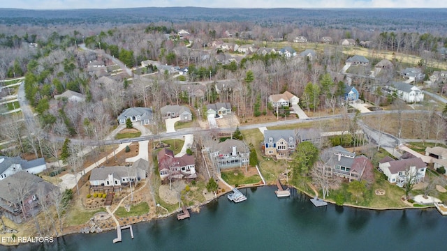 bird's eye view with a residential view, a view of trees, and a water view