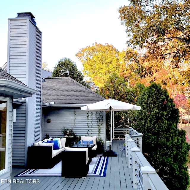 wooden terrace featuring an outdoor hangout area