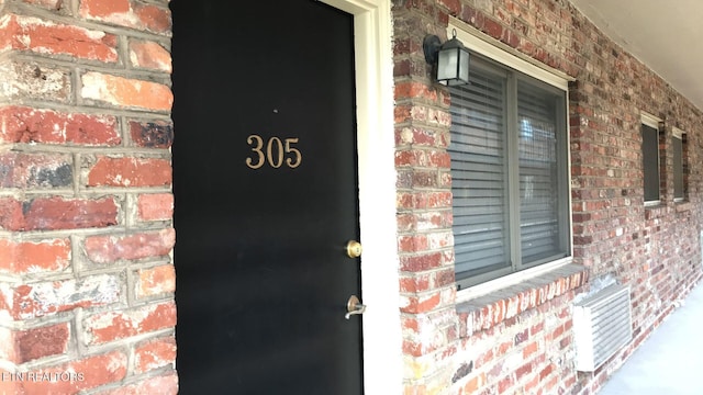 property entrance with brick siding