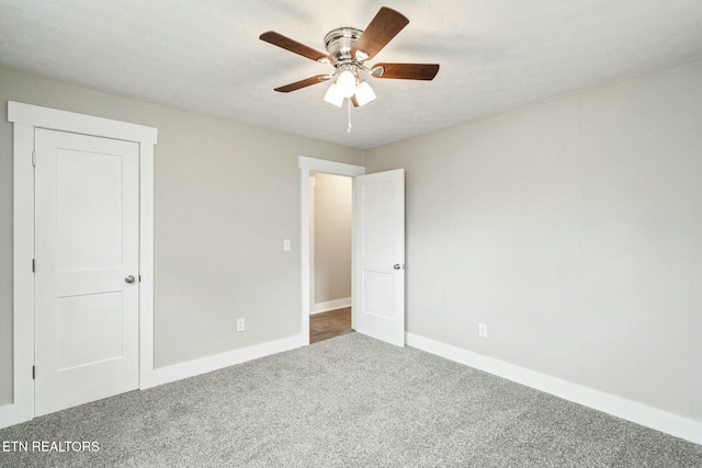 unfurnished bedroom featuring baseboards, carpet floors, and a ceiling fan