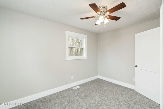 carpeted empty room featuring visible vents, a textured ceiling, a ceiling fan, and baseboards