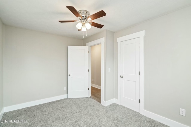 unfurnished bedroom featuring baseboards, carpet floors, and ceiling fan