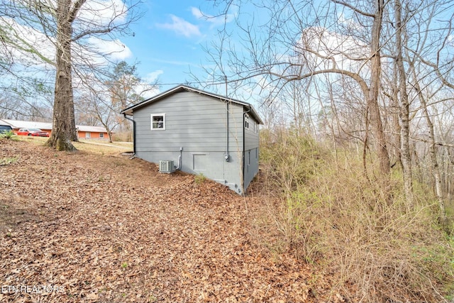 view of side of home with central AC and crawl space