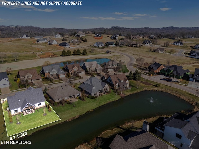 drone / aerial view featuring a residential view and a water view
