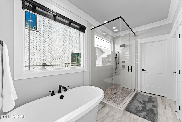 full bathroom with a freestanding tub, plenty of natural light, marble finish floor, and a stall shower