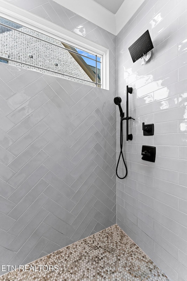 bathroom with tiled shower