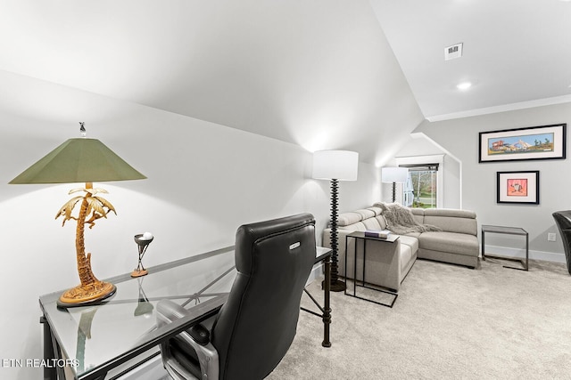 home office with visible vents, baseboards, light colored carpet, and vaulted ceiling