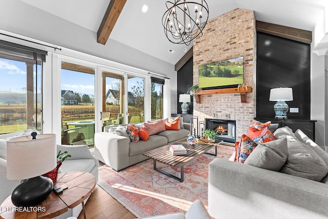 living room with beamed ceiling, a fireplace, an inviting chandelier, wood finished floors, and high vaulted ceiling