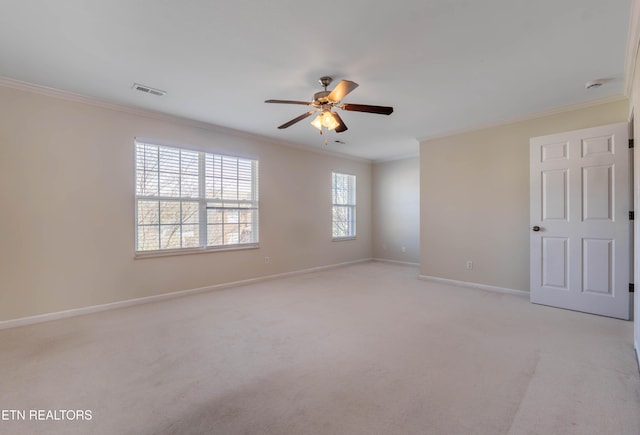 spare room featuring crown molding, light carpet, baseboards, visible vents, and ceiling fan