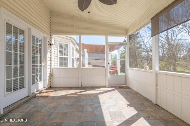 unfurnished sunroom with ceiling fan and a healthy amount of sunlight