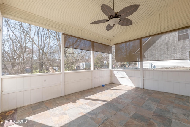 unfurnished sunroom with ceiling fan