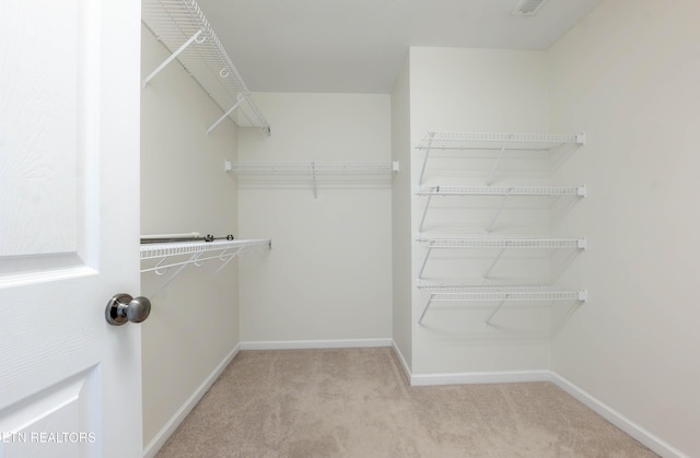 walk in closet with carpet