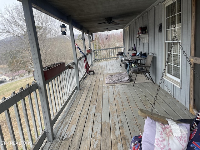 deck featuring covered porch and ceiling fan