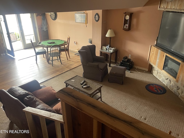 living area with wood finished floors and baseboards