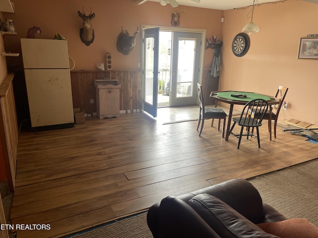 dining room featuring wainscoting, ceiling fan, and wood finished floors