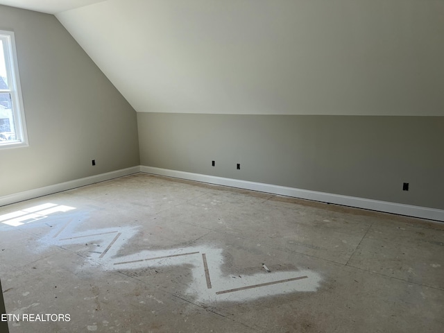 bonus room featuring baseboards and lofted ceiling