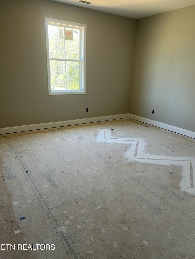 empty room with visible vents and baseboards