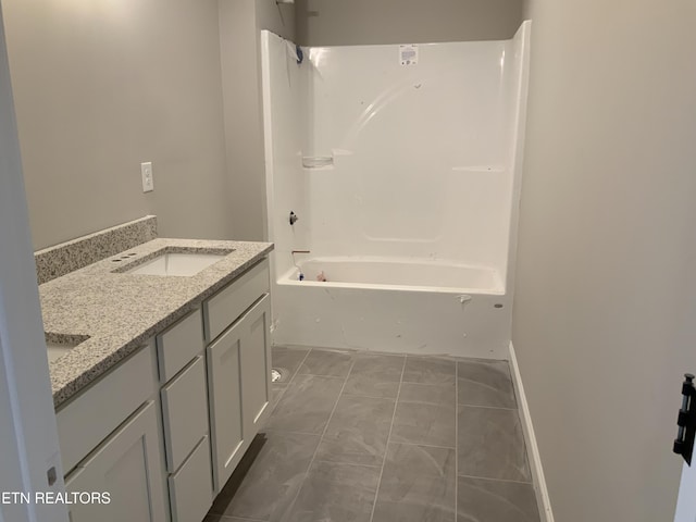 bathroom with tub / shower combination, marble finish floor, a sink, and double vanity