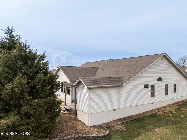 view of home's exterior with roof with shingles