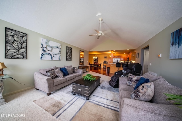 living room with vaulted ceiling, light colored carpet, baseboards, and ceiling fan