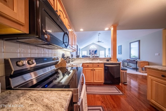 kitchen with dishwashing machine, decorative columns, a sink, vaulted ceiling, and stainless steel range with electric stovetop