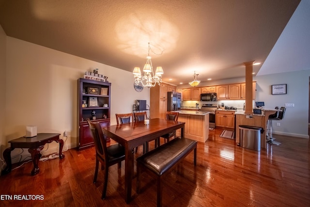 dining space featuring dark wood-style floors, a notable chandelier, recessed lighting, and baseboards