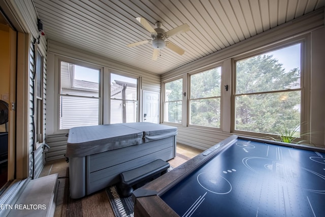 sunroom / solarium with a ceiling fan