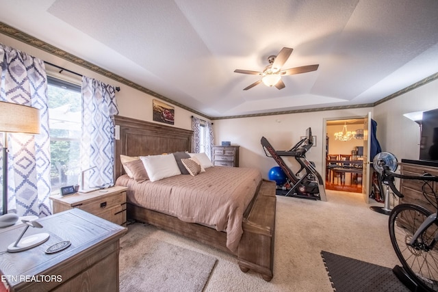 bedroom with light carpet, ornamental molding, ceiling fan with notable chandelier, a tray ceiling, and lofted ceiling