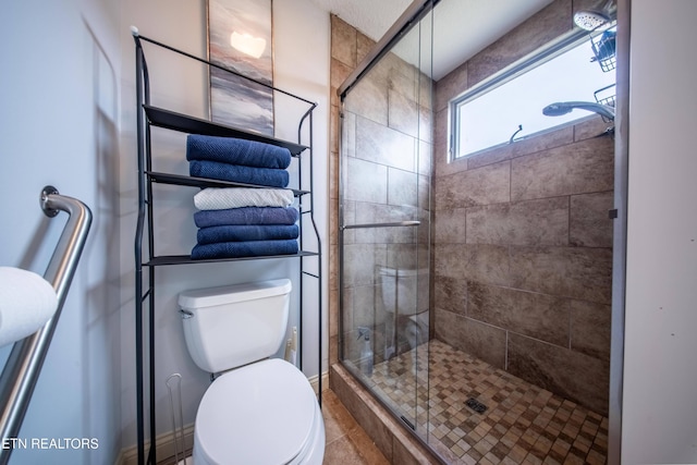 full bath featuring a shower stall and toilet